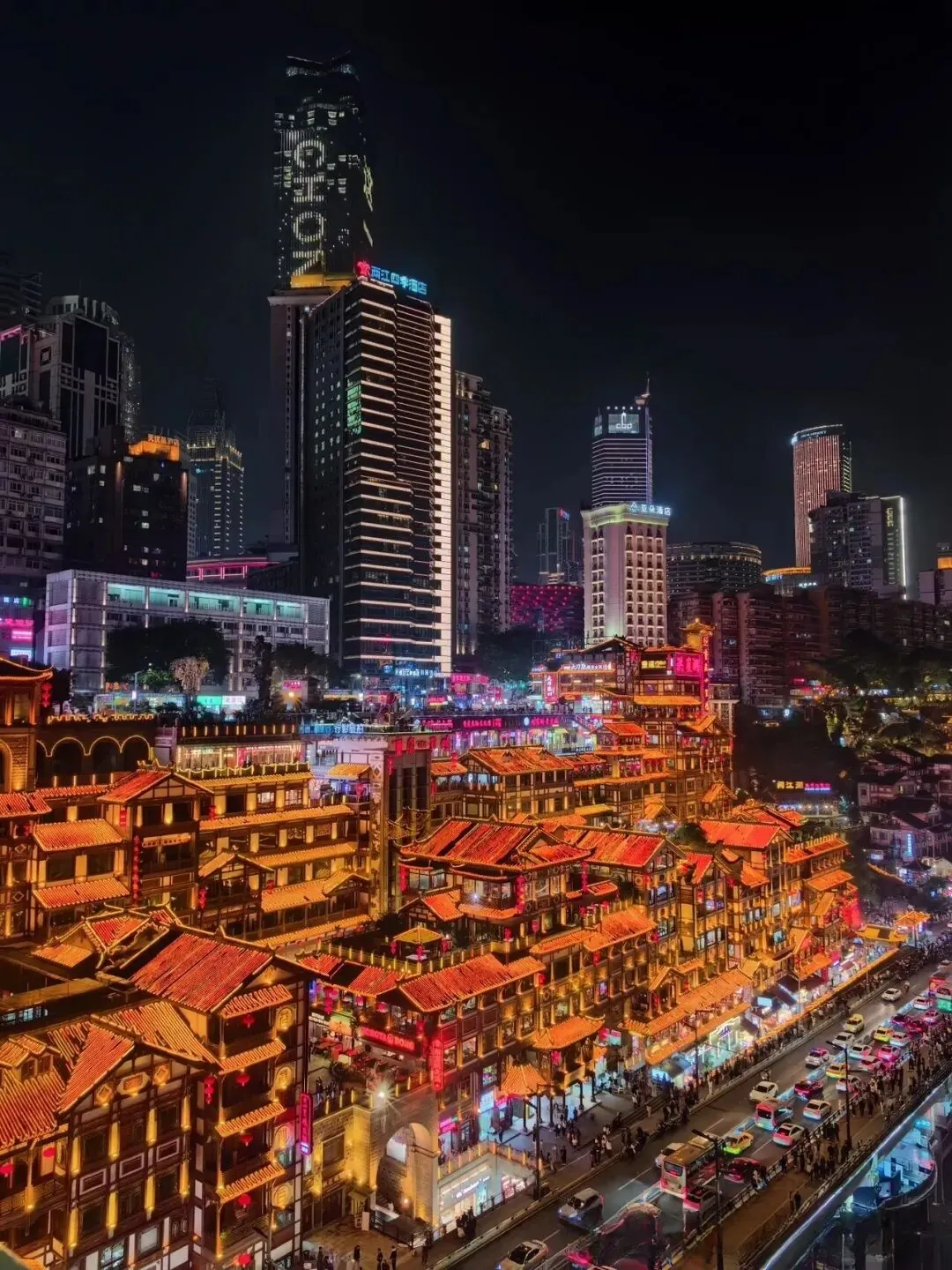 Hongya Cave stacked stilt-house complex lit up at night in Chongqing