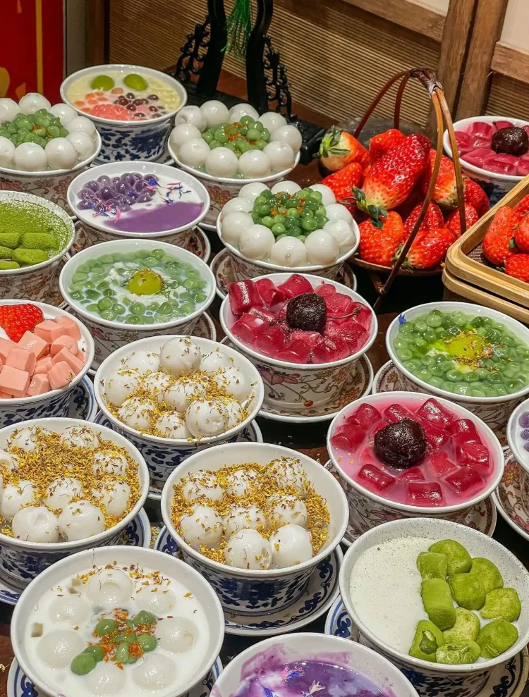 A table of tangyuan dessert bowls topped with osmanthus at a Shanghai sweets shop