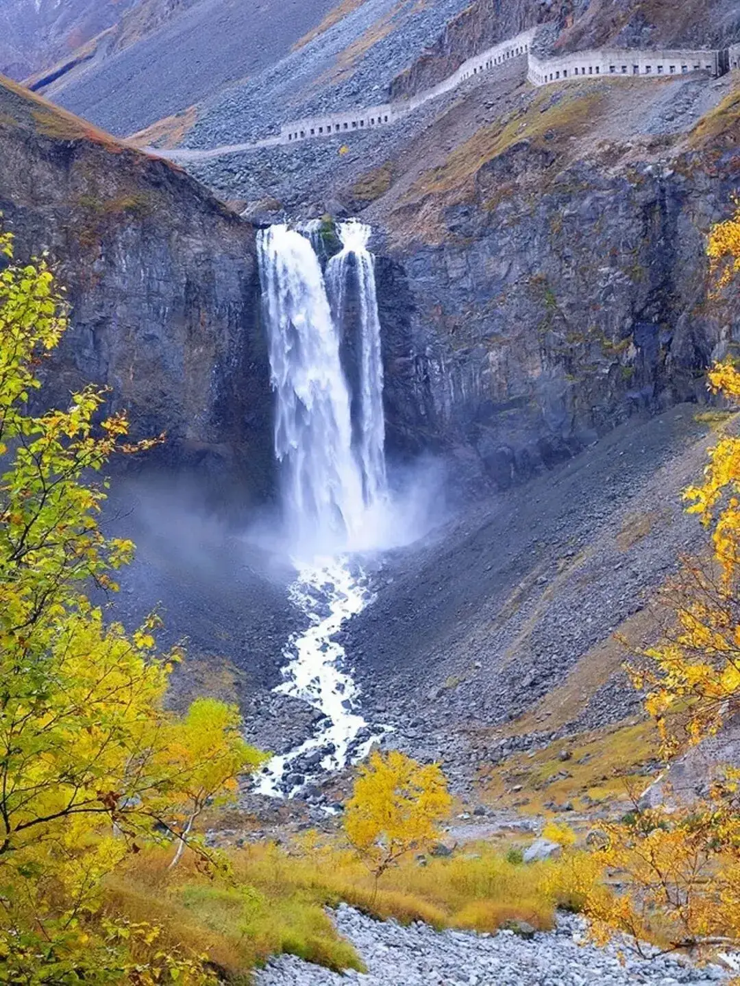 Changbai Waterfall white ribbon down the cliff in autumn